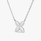 Marwa Jewels silver necklace with a polished four-petal flower pendant on a fine chain
