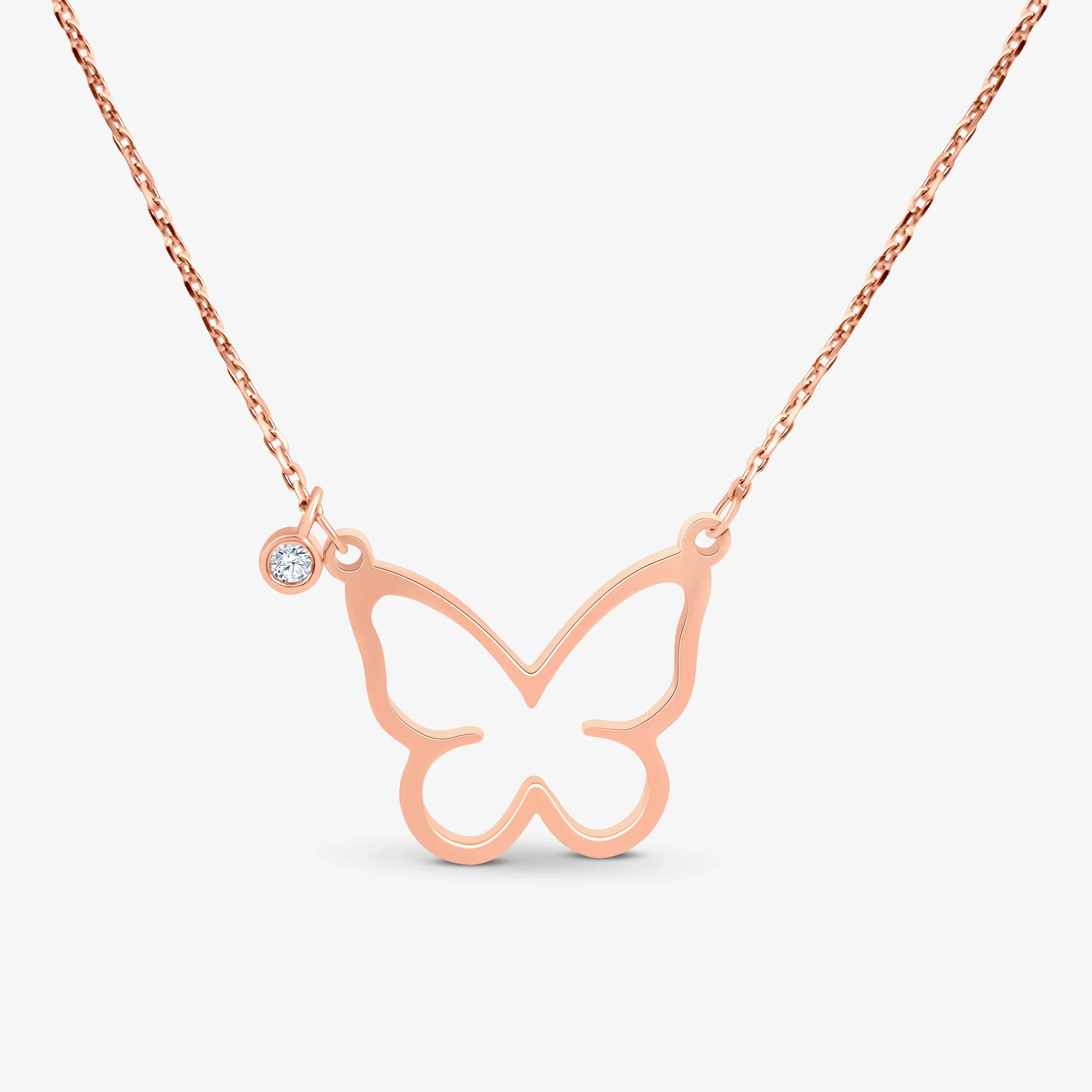Rose gold butterfly pendant necklace with a small clear gemstone charm on delicate chain