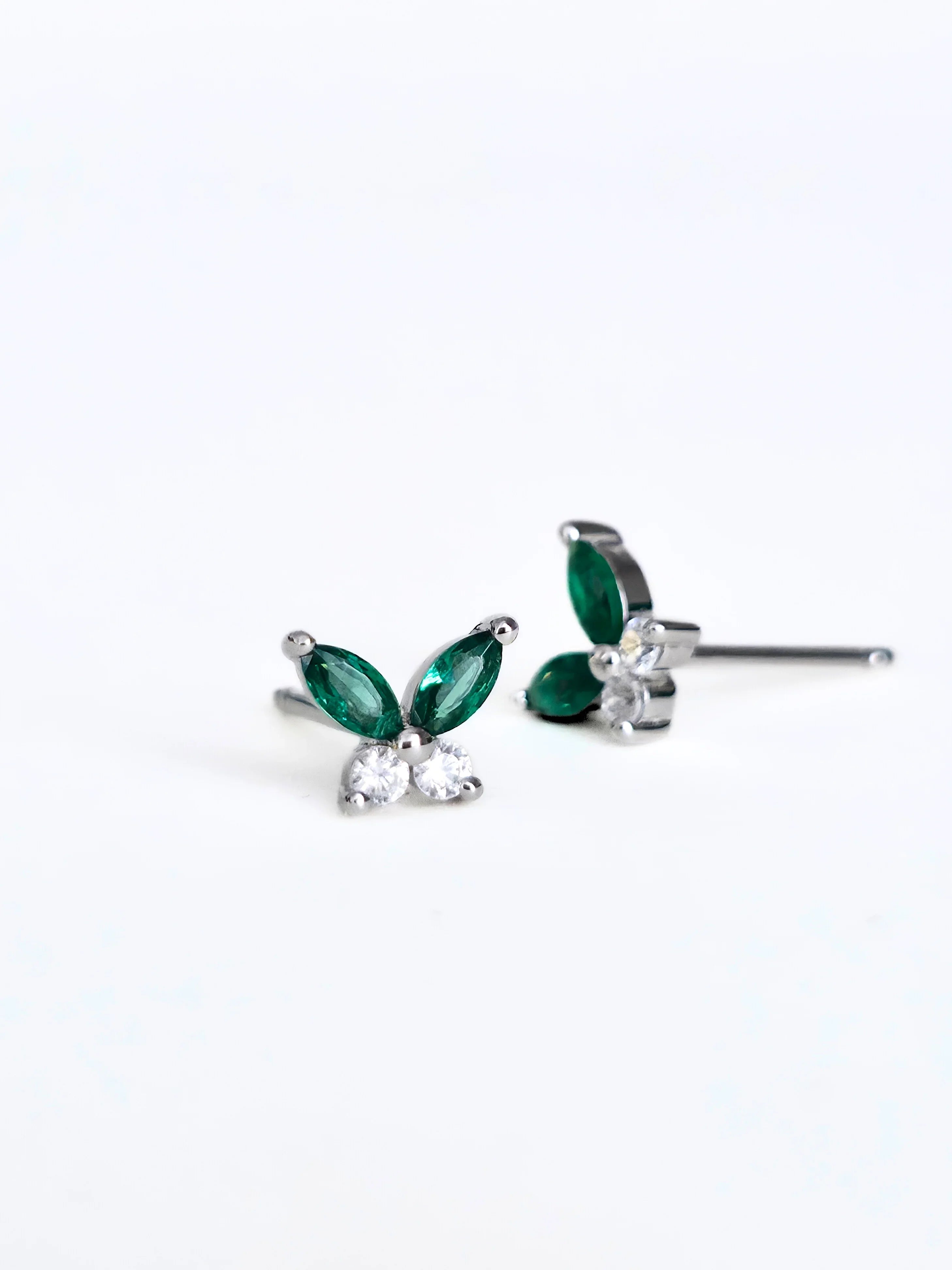 Butterfly-shaped earrings with green and clear gemstones on a white -background 1 pair