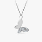 Silver butterfly pendant necklace with one wing encrusted with sparkling crystals on chain