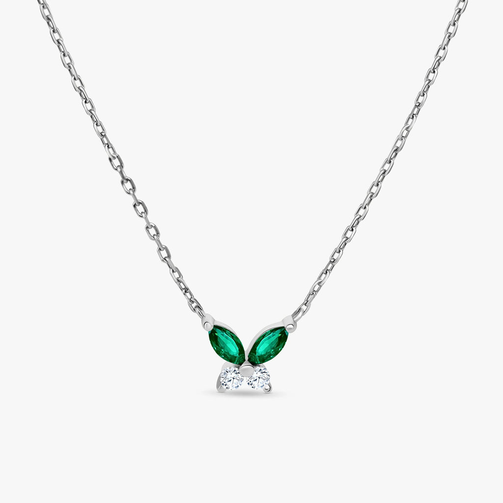 Silver chain necklace with butterfly-shaped pendant featuring green emerald and clear diamond stones