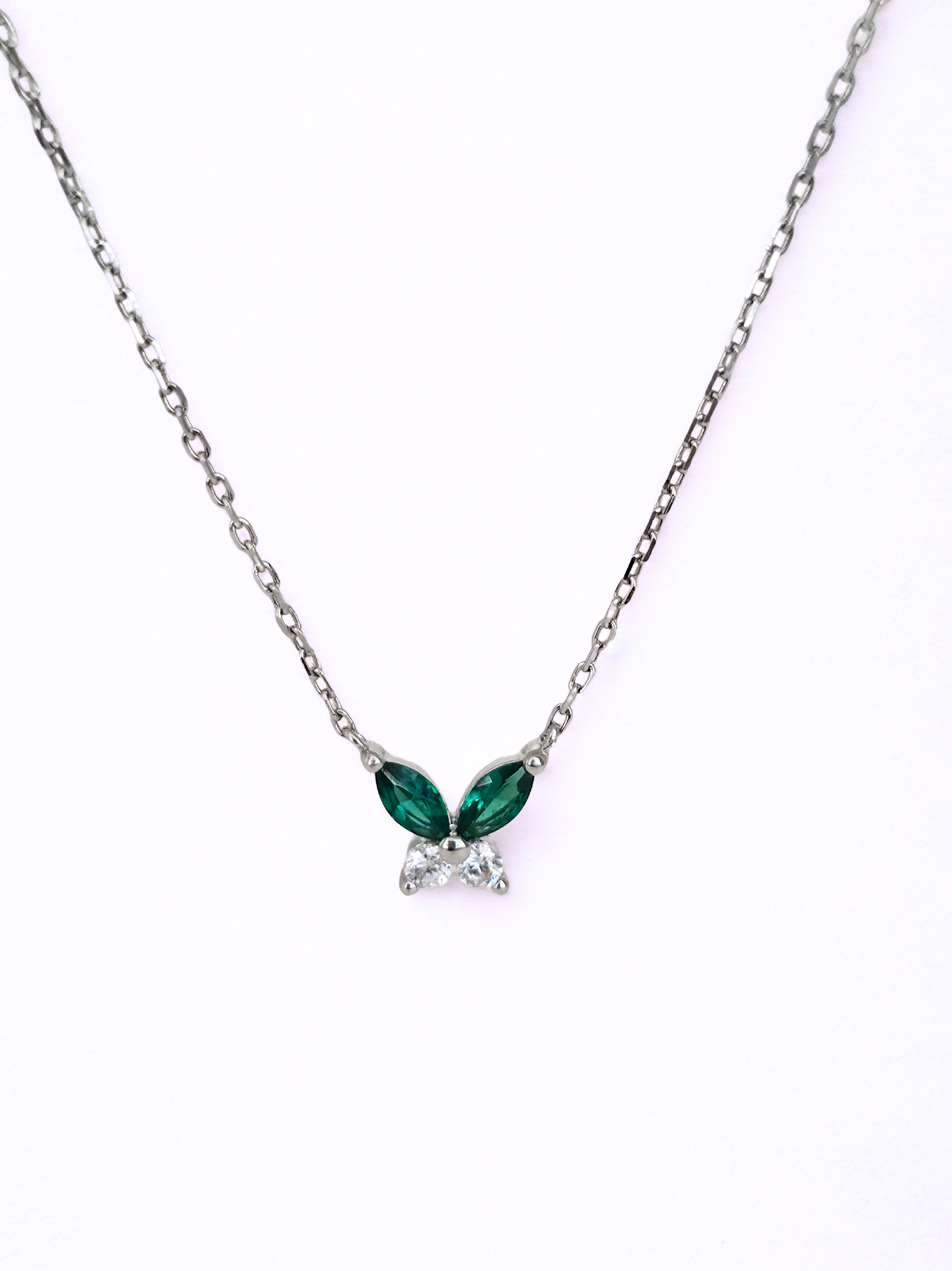 petite butterfly necklace silver Necklace with green gemstones on a white background- front