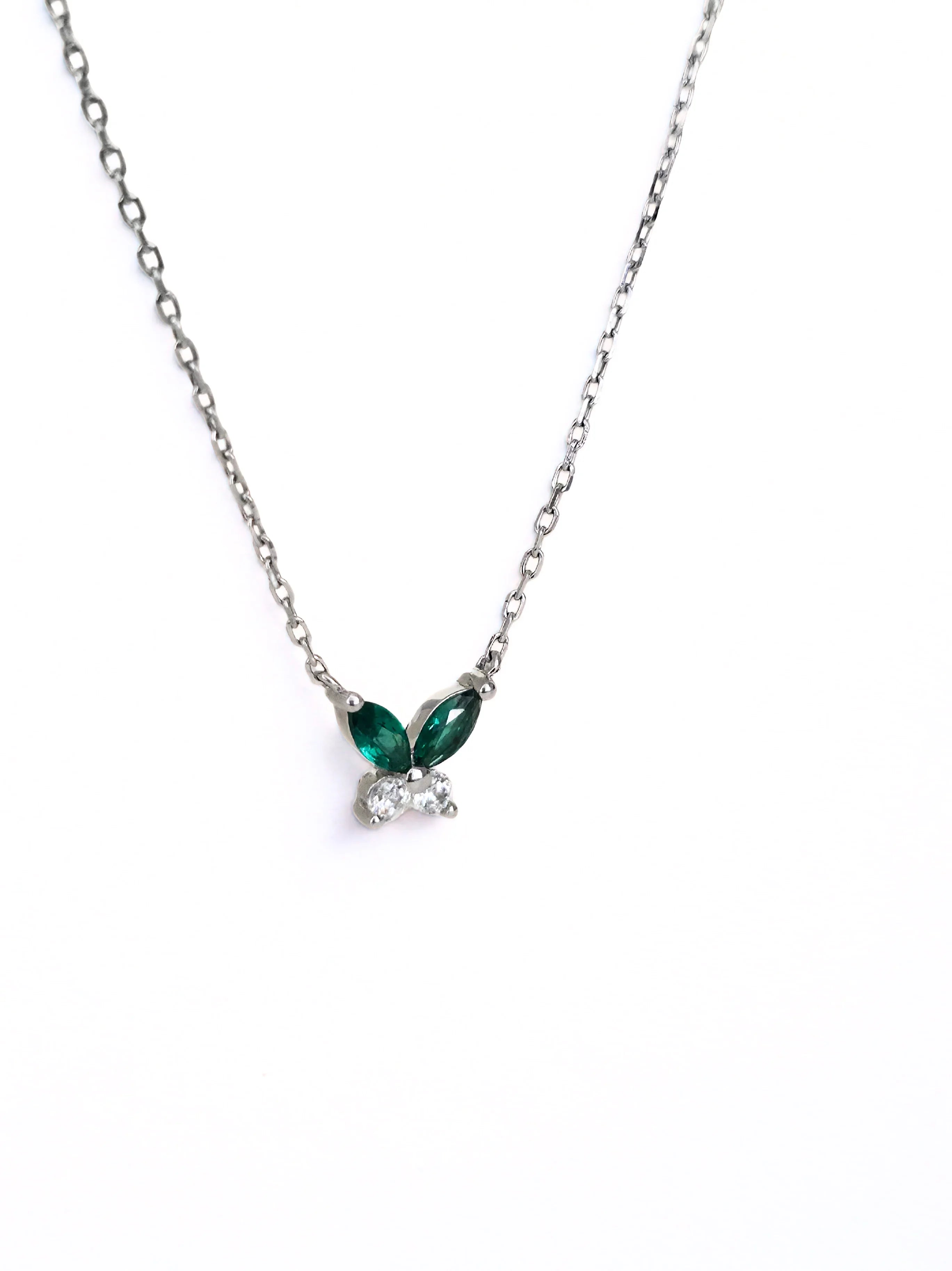 petite butterfly necklace silver Necklace with green gemstones on a white background- side ways