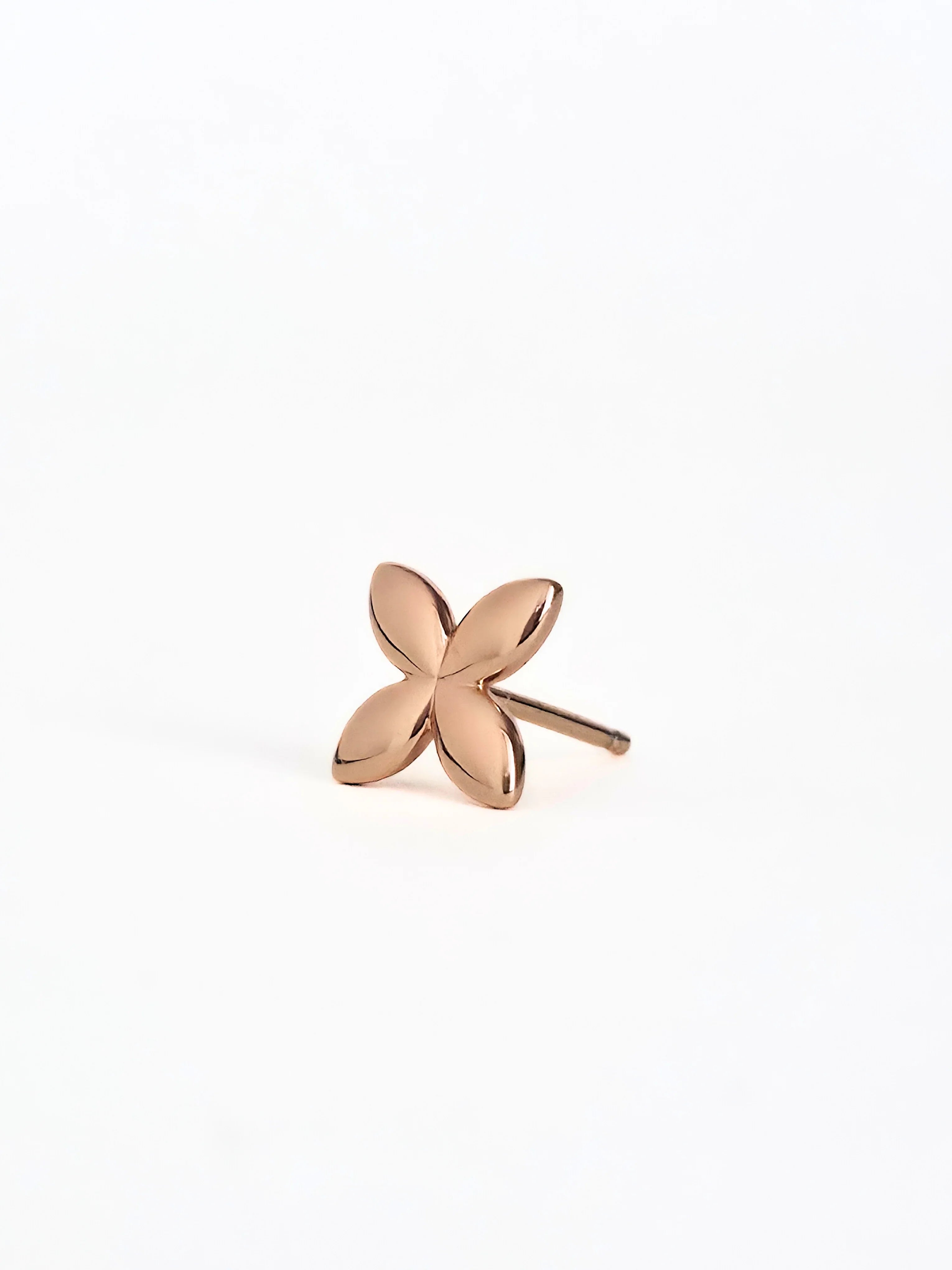 Rose gold flower-shaped earring on a white background= front