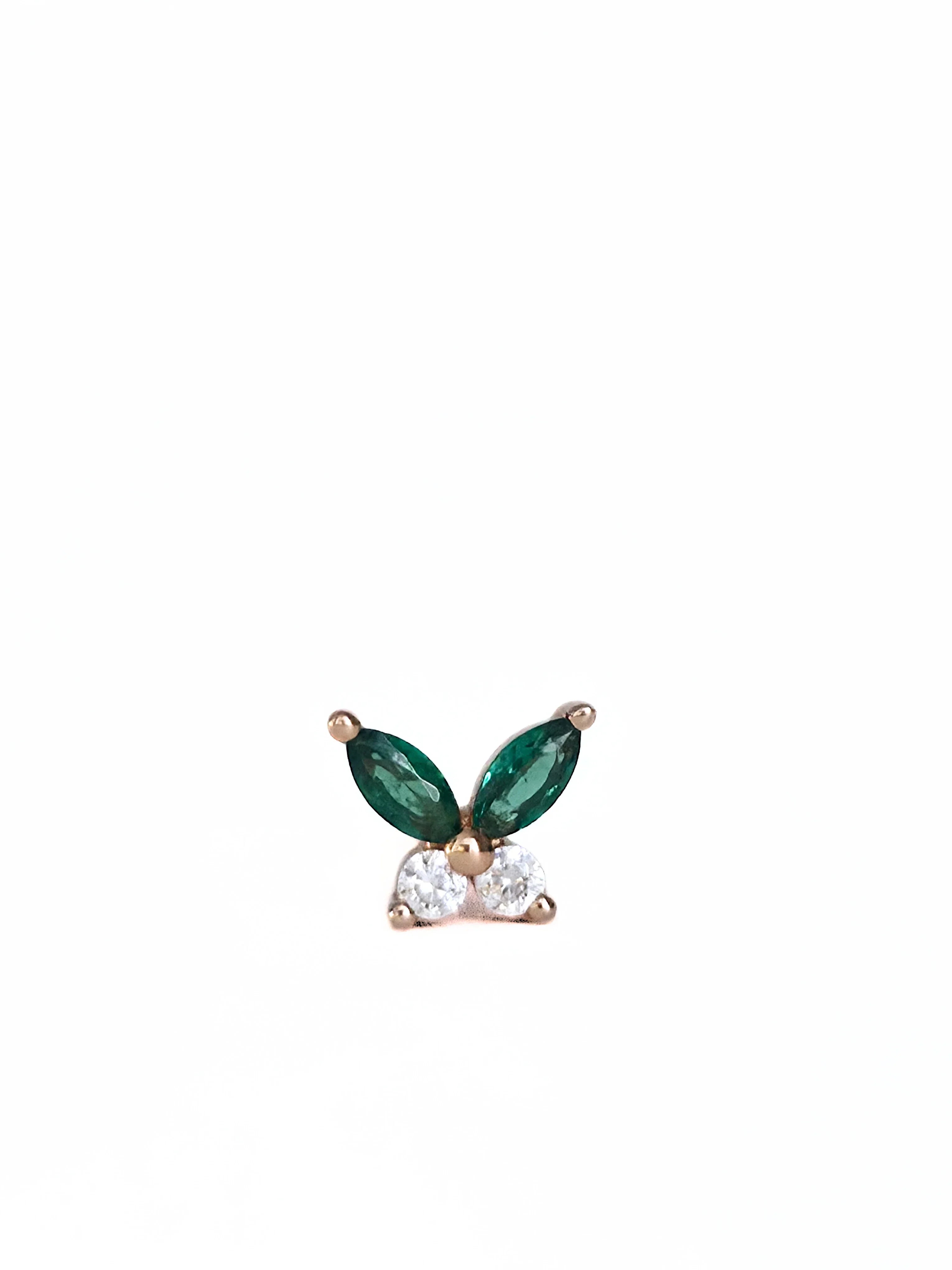 Dainty earring with gr- side ways een gemstones and a diamond on a white background side ways