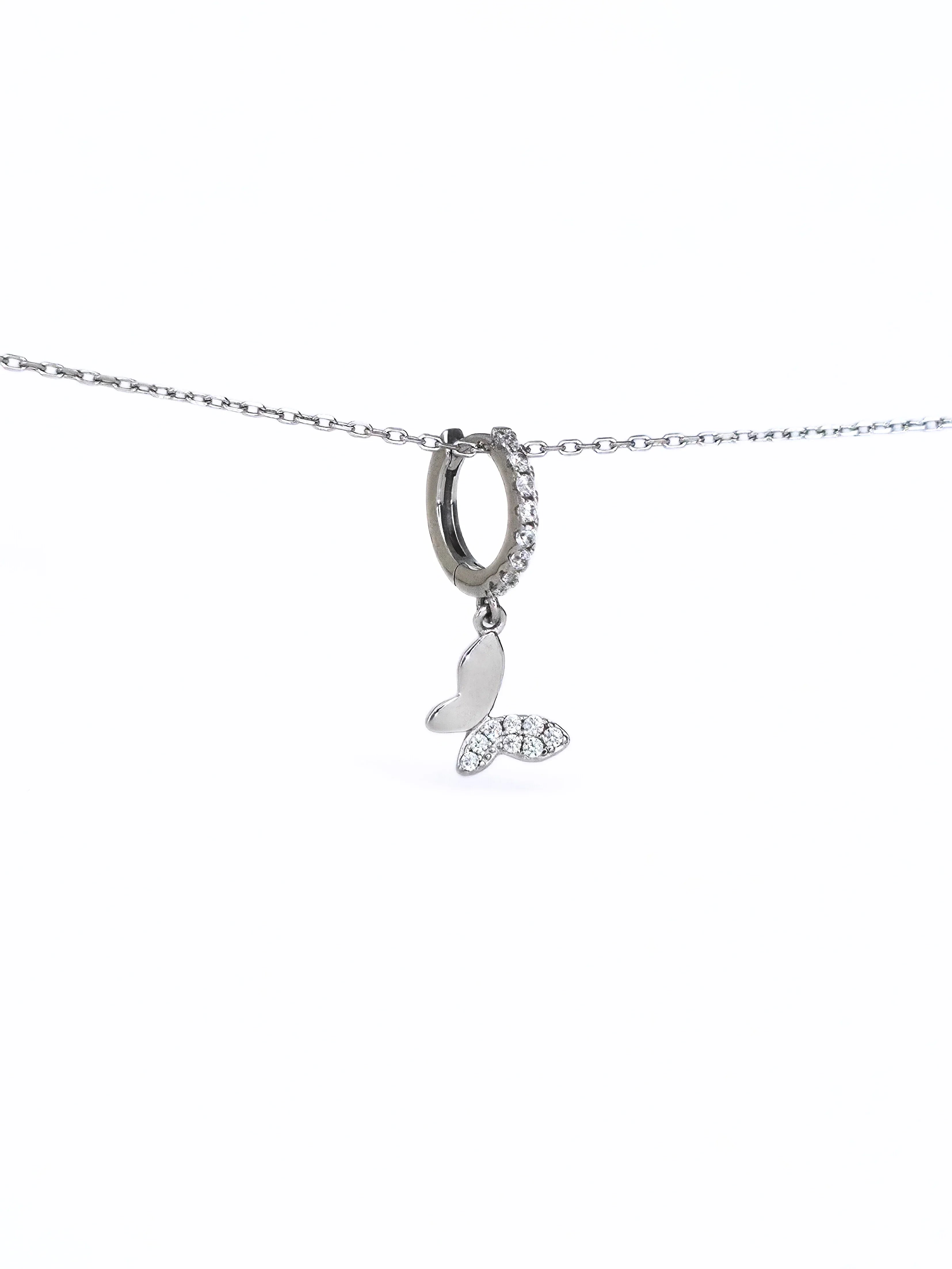 Silver necklace with a butterfly huggieson a white background- further
