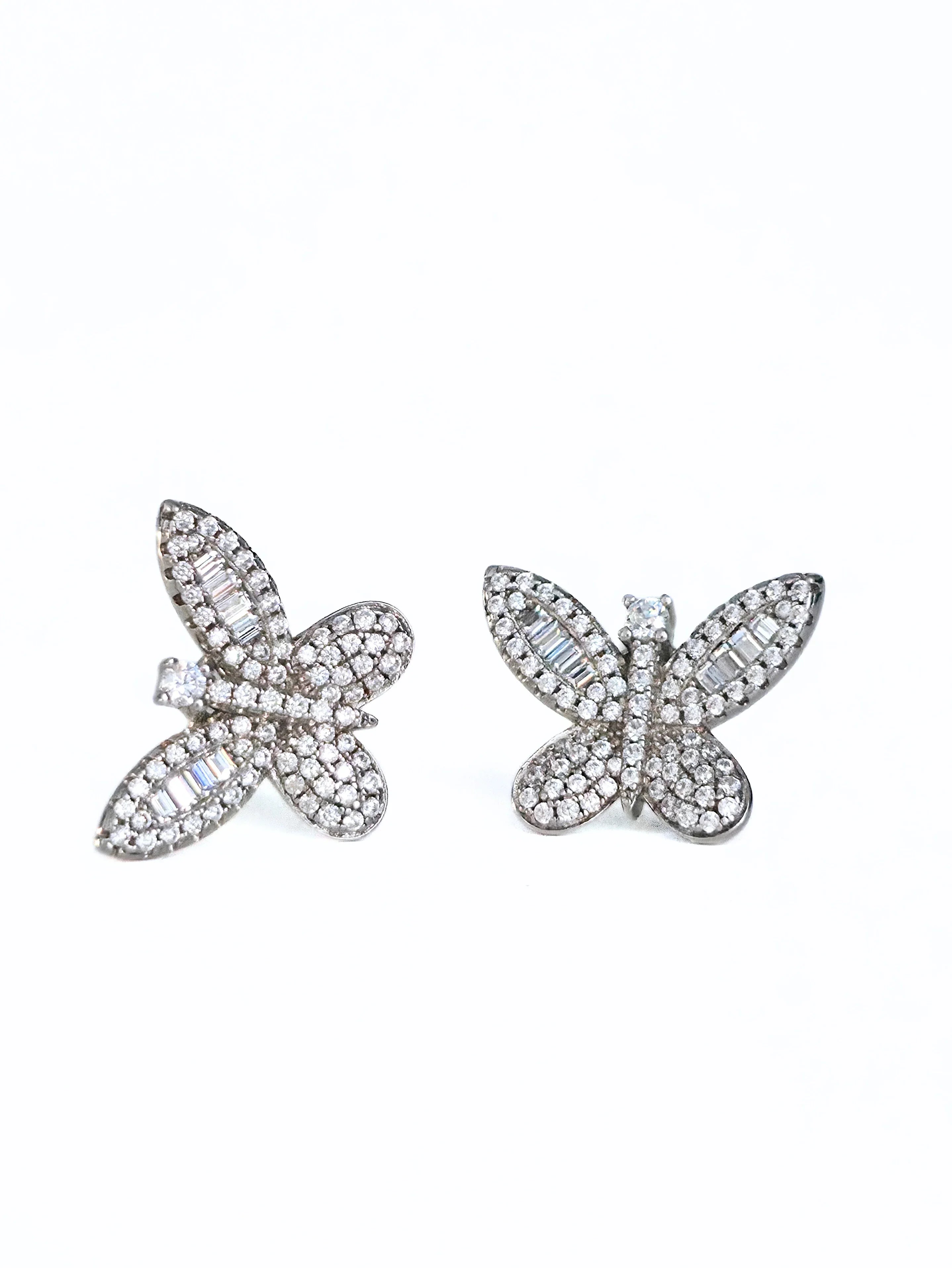Butterfly-shaped jewelry piece with gemstones on a white background- front- shimmering- pair butterfly earrings silver