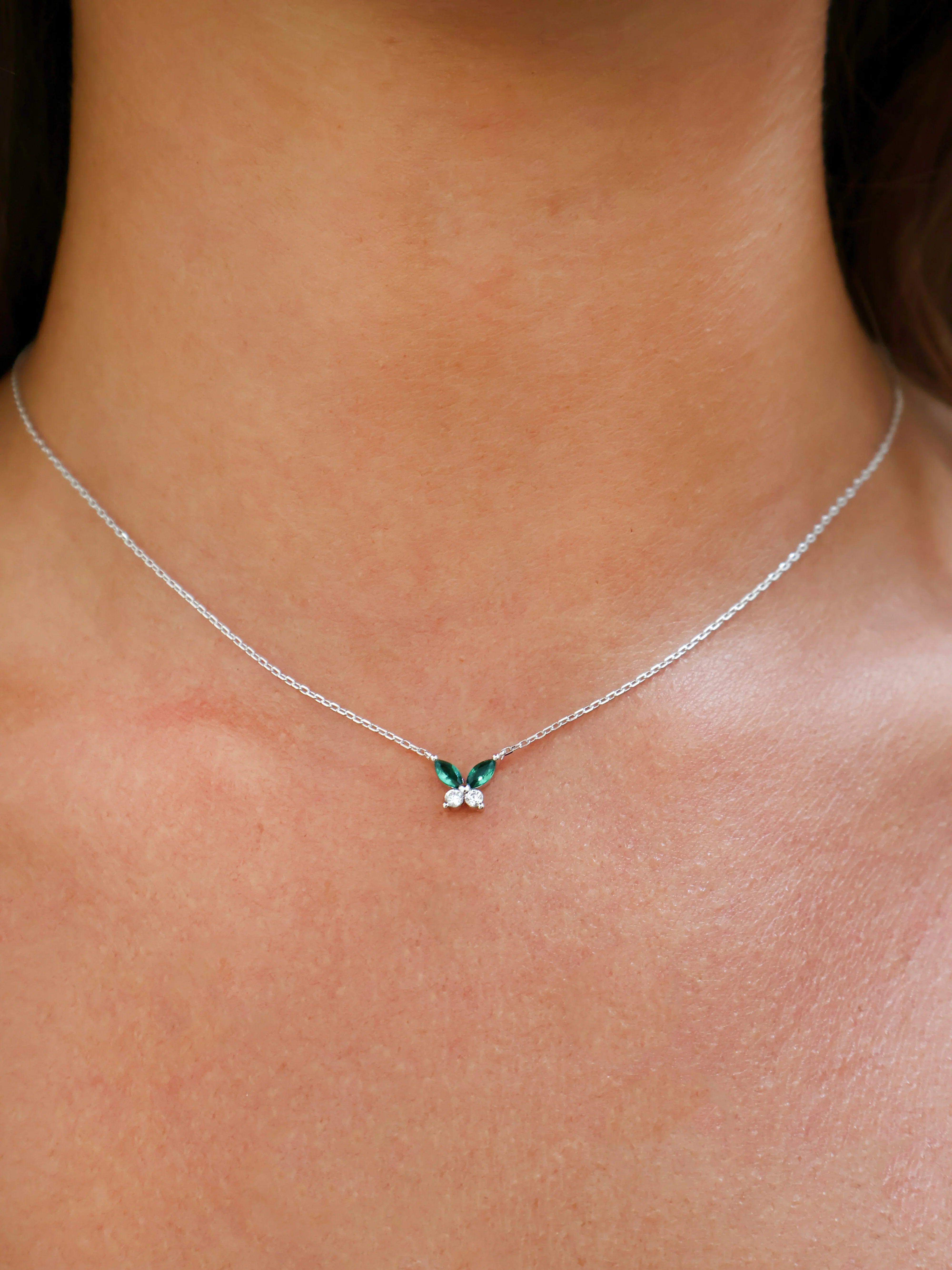 Silver necklace with marquise-cut green gemstones and round clear stones pendant from Marwa Jewels