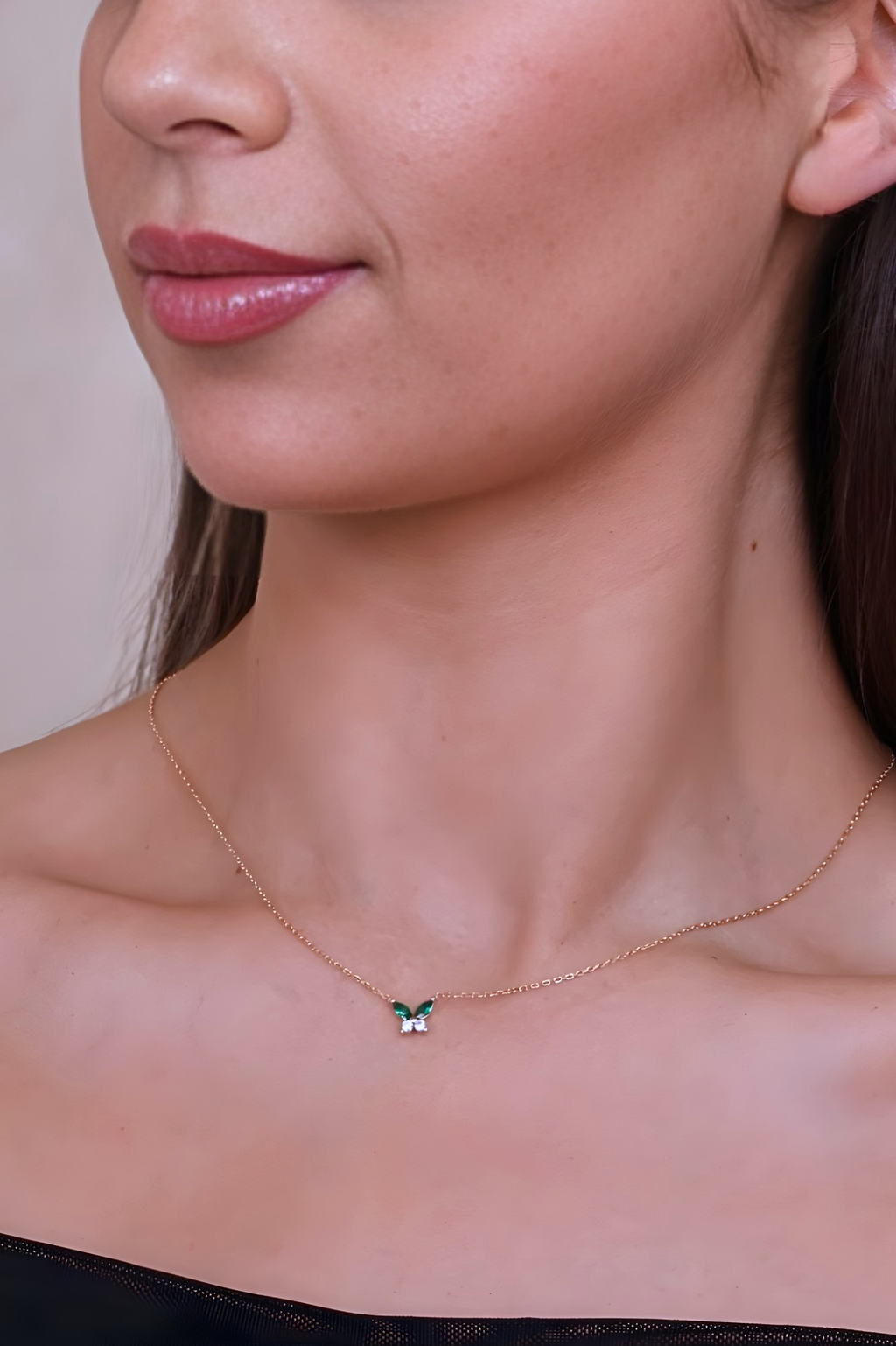 Necklace with a green pendant worn by a person