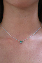 Necklace with a butterfly pendant on a person's neck