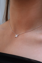 Necklace with a small pendant worn by a person