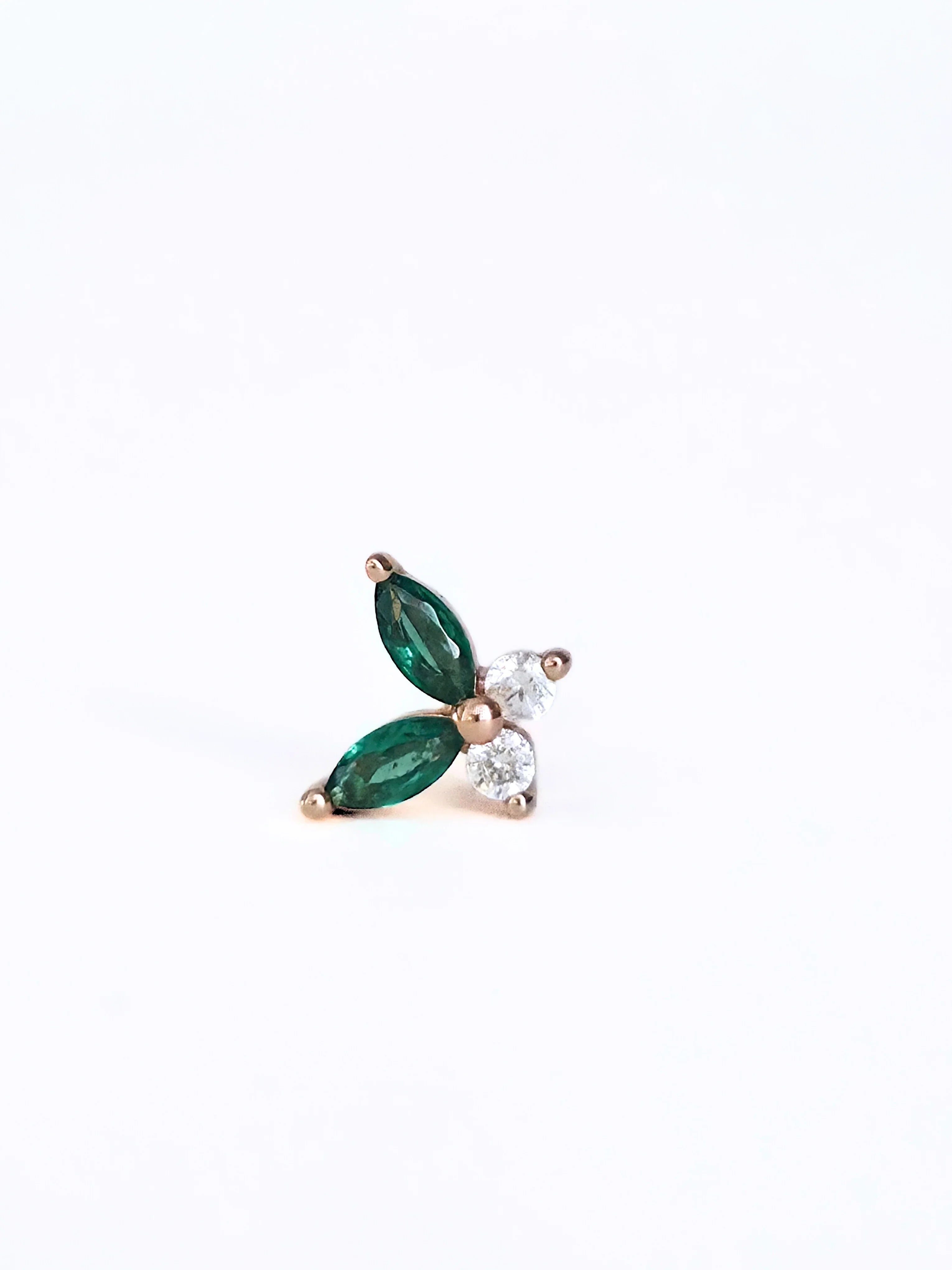 Dainty earring with gr- side ways een gemstones and a diamond on a white background side ways