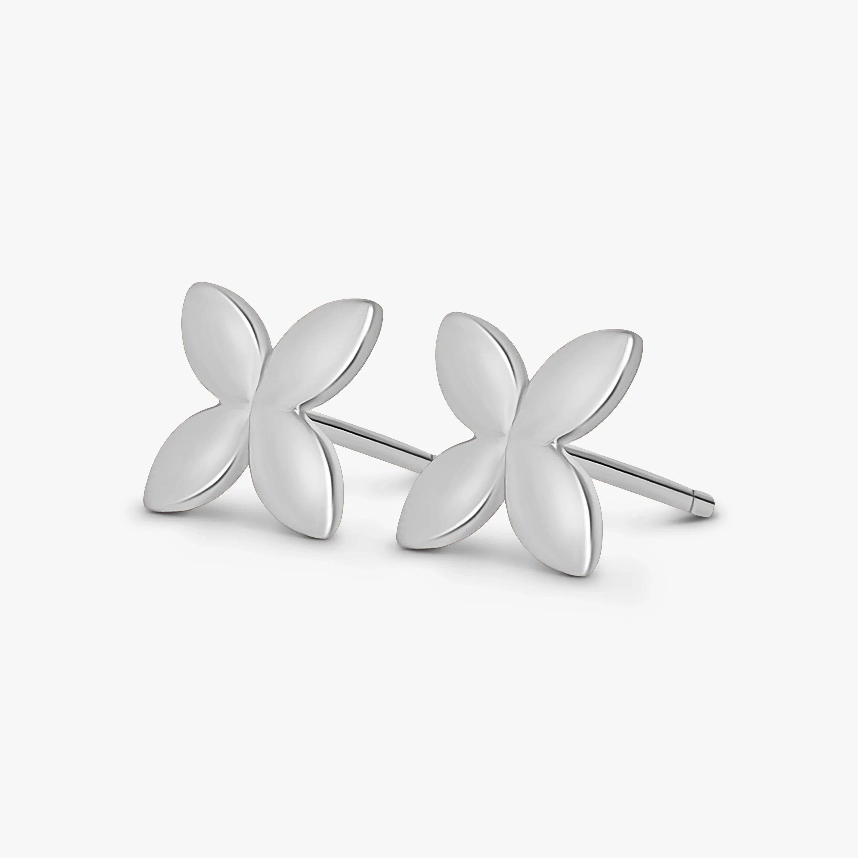 Pair of silver butterfly-shaped stud earrings on a white background