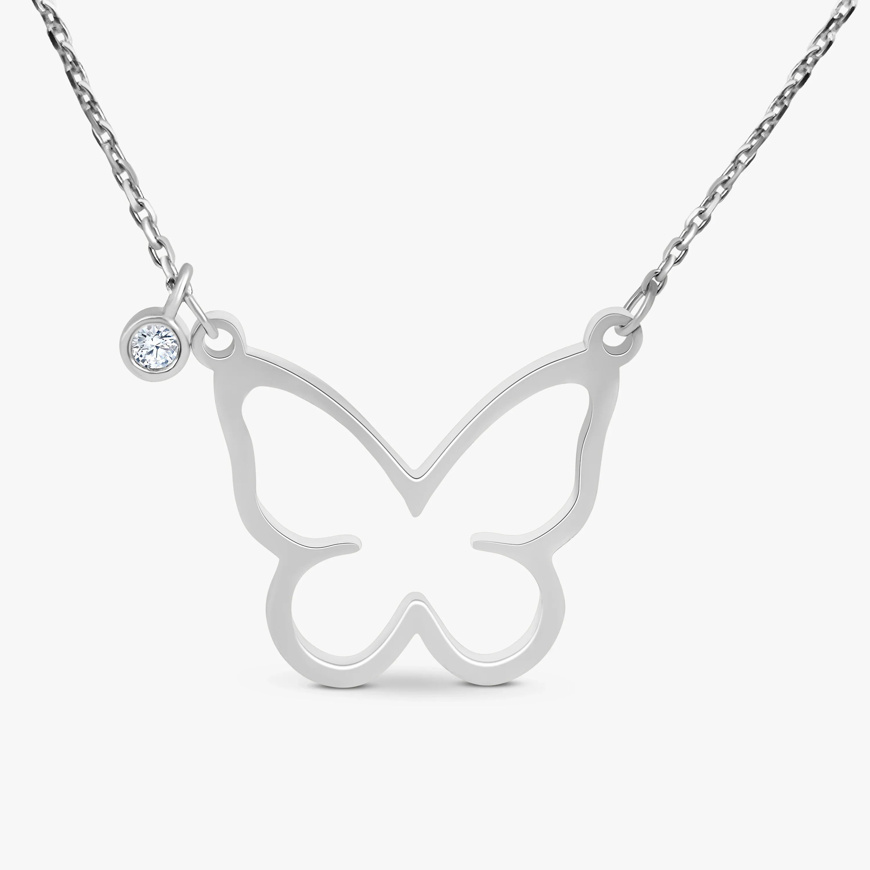Silver butterfly pendant necklace with a small clear gemstone charm on a fine chain, minimalist jewellery