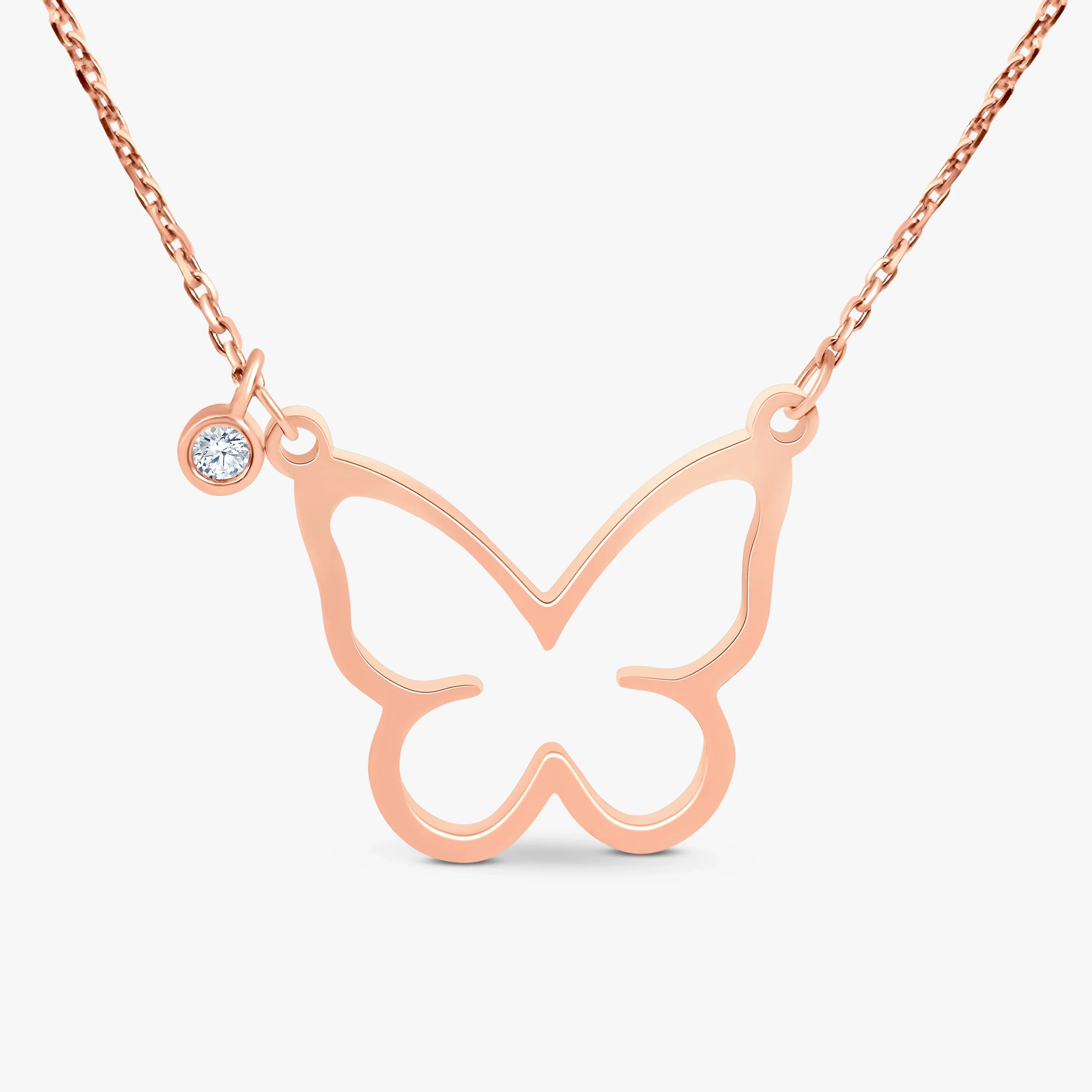 Rose gold butterfly pendant necklace with a small diamond charm on a delicate chain