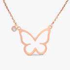 Rose gold butterfly pendant necklace with a small diamond charm on a delicate chain