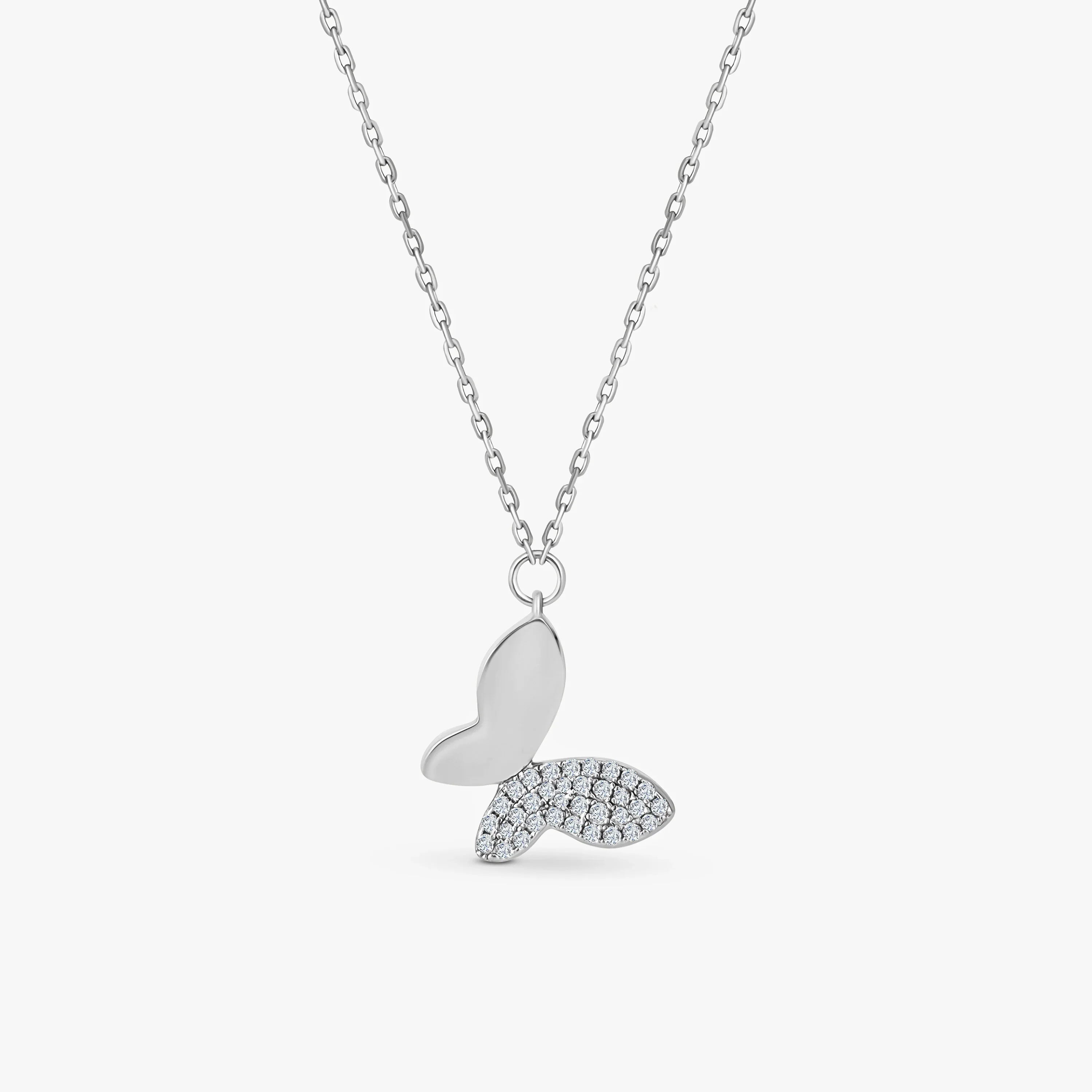 Silver butterfly pendant necklace with one wing studded with diamonds on delicate chain