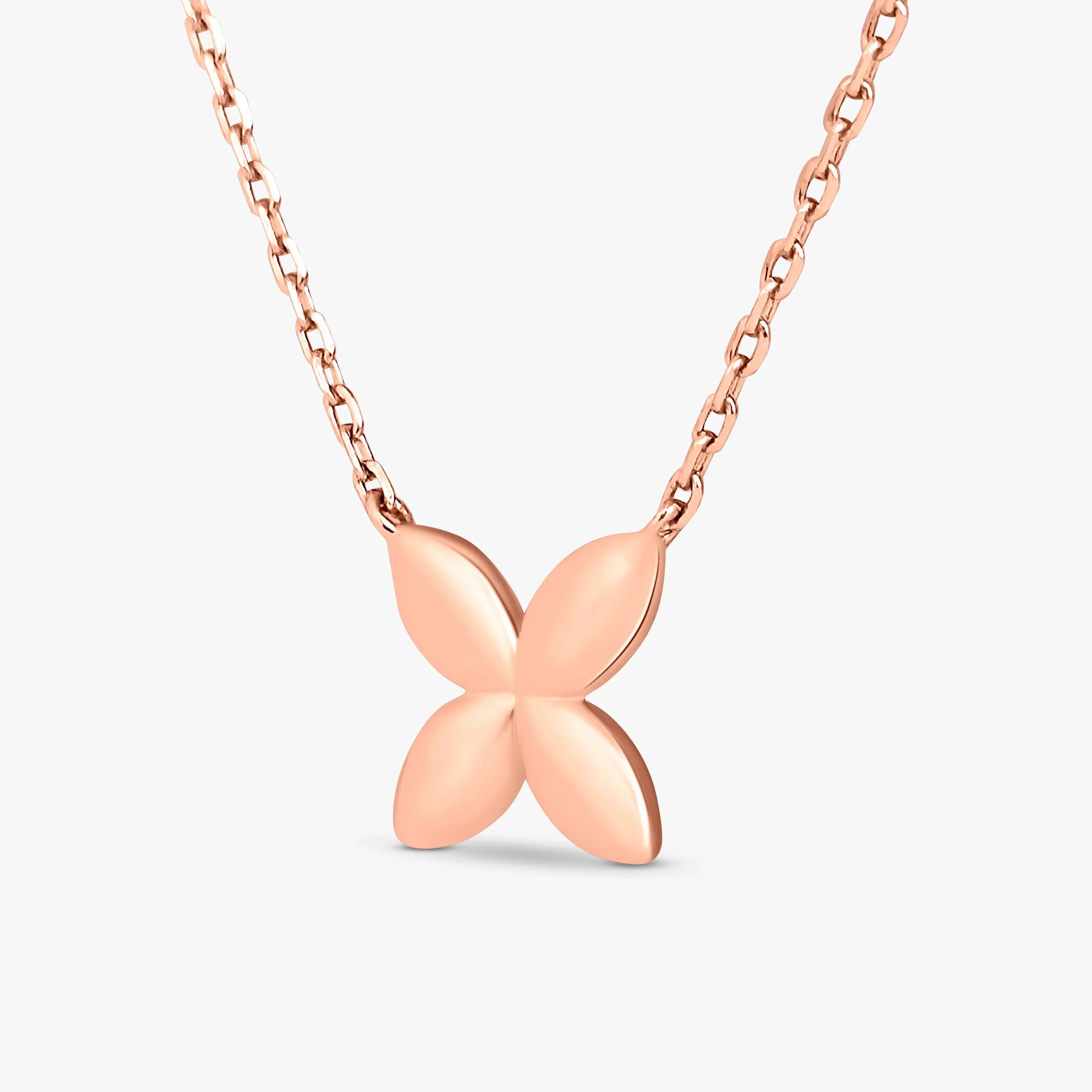 Rose gold necklace with a smooth four-petal flower pendant on a modern chain