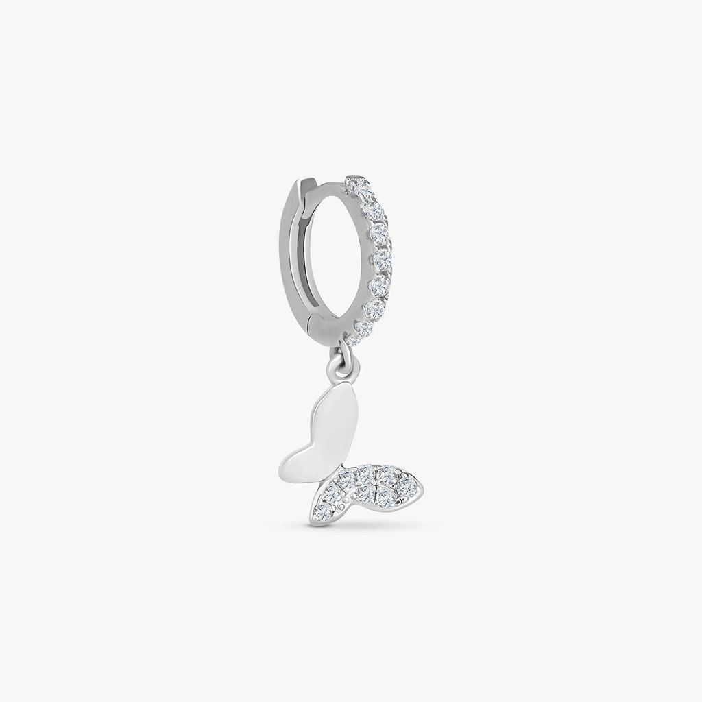 Silver hoop earring with clear crystals and a dangling butterfly charm featuring crystal accents