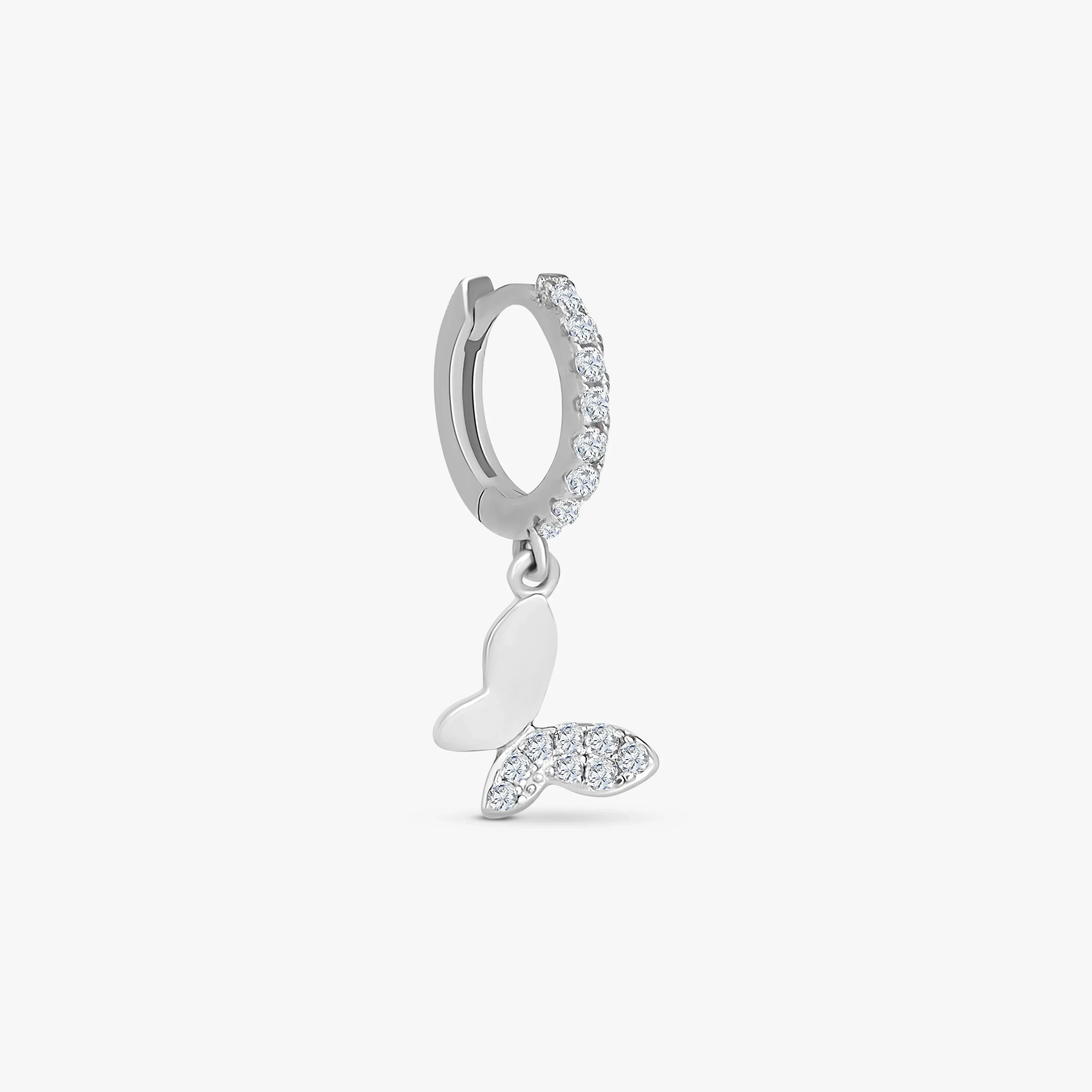 Silver hoop earring with clear crystals and a dangling butterfly charm featuring crystal accents