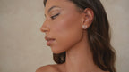 video of a girl wearing an open butterfly earring